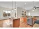 Spacious kitchen with island, granite counters, and hardwood floors at 4280 Crystal Dr, Broomfield, CO 80023