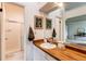 Updated bathroom featuring a clean white sink, well lit mirror, and a shower with glass doors at 4621 S Fraser Cir # A, Aurora, CO 80015