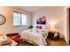 Charming bedroom with large window, airplane art and a comfortable queen bed at 4621 S Fraser Cir # A, Aurora, CO 80015
