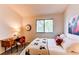 Bright bedroom with a large window, comfortable bed and stylish desk area at 4621 S Fraser Cir # A, Aurora, CO 80015