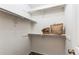 Walk-in closet featuring ample shelving and storage space for organizing wardrobe and accessories at 4621 S Fraser Cir # A, Aurora, CO 80015