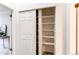 Open closet with built-in shelving for optimal storage solutions at 4621 S Fraser Cir # A, Aurora, CO 80015