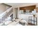 Dining area open to the kitchen, with a glass table and staircase in view at 4621 S Fraser Cir # A, Aurora, CO 80015