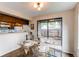 Dining room with view to kitchen and outdoor area, featuring a glass table at 4621 S Fraser Cir # A, Aurora, CO 80015