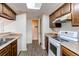 Bright and functional kitchen with wooden cabinets and updated appliances for convenient cooking at 4621 S Fraser Cir # A, Aurora, CO 80015