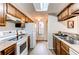 Efficient kitchen featuring wooden cabinets, updated appliances, and a skylight for natural light at 4621 S Fraser Cir # A, Aurora, CO 80015