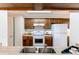 Charming kitchen features wooden cabinets, updated appliances, and a bright, welcoming atmosphere at 4621 S Fraser Cir # A, Aurora, CO 80015