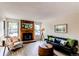 Cozy living room featuring a beautiful fireplace and plenty of natural light from large windows at 4621 S Fraser Cir # A, Aurora, CO 80015
