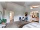 Serene main bedroom with neutral carpeting and a view into the main bathroom and natural light at 4621 S Fraser Cir # A, Aurora, CO 80015