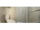 Bathroom featuring a white toilet and a shower with a glass door at 11299 E 159Th Pl, Brighton, CO 80602