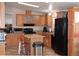 Kitchen with center island, wood cabinets, and modern appliances at 11299 E 159Th Pl, Brighton, CO 80602