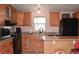 Traditional kitchen featuring wood cabinets, laminate countertops, and black appliances at 11299 E 159Th Pl, Brighton, CO 80602