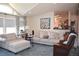 Cozy living room with plush seating, a modern painting, and vaulted ceilings at 11299 E 159Th Pl, Brighton, CO 80602