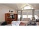 Living room with vaulted ceilings, large windows and stylish curtains at 11299 E 159Th Pl, Brighton, CO 80602