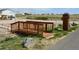 Landscaped yard with a wooden bridge leading to the mailbox at 11299 E 159Th Pl, Brighton, CO 80602
