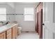 Bright bathroom featuring double sinks, tile floors, and a shower/tub combo at 11538 Hudson St, Thornton, CO 80233