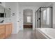 Bathroom with a bathtub, a glass shower and a view into the bedroom at 11538 Hudson St, Thornton, CO 80233