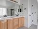 Bathroom featuring double sinks, tile floors, and a glass-enclosed shower at 11538 Hudson St, Thornton, CO 80233