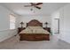 Spacious bedroom featuring a large bed, neutral carpet, and a walk-in bathroom at 11538 Hudson St, Thornton, CO 80233