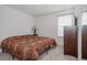Standard bedroom with neutral carpet, a window for natural light and an end table at 11538 Hudson St, Thornton, CO 80233