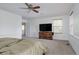 Bright bedroom with neutral carpet, a window for natural light and TV on bureau at 11538 Hudson St, Thornton, CO 80233