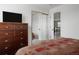 Bedroom featuring carpeted floors, dresser, mirrored closet, and access to another room at 11538 Hudson St, Thornton, CO 80233