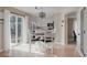 Bright dining area with a white table set, hardwood floors, and sliding glass door at 11538 Hudson St, Thornton, CO 80233