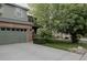 Charming two-story home featuring a brick facade, green siding, and a well-manicured front yard at 11538 Hudson St, Thornton, CO 80233