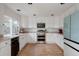 Bright kitchen with white cabinets, stainless steel appliances, and hardwood floors at 11538 Hudson St, Thornton, CO 80233