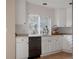 Modern kitchen featuring white cabinets, stainless steel appliances, and a black dishwasher at 11538 Hudson St, Thornton, CO 80233