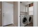 Functional laundry room with modern washer and dryer and cabinet storage at 11538 Hudson St, Thornton, CO 80233