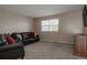 Inviting living room with neutral walls, neutral carpet and large leather couch at 11538 Hudson St, Thornton, CO 80233