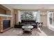 Comfortable living room featuring a fireplace, carpet, and a large window at 11538 Hudson St, Thornton, CO 80233