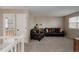 Upstairs living area with comfortable seating, neutral decor, and access to the bathroom at 11538 Hudson St, Thornton, CO 80233