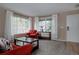 Bright living room with large windows, neutral paint, elegant curtains, and cozy seating at 11538 Hudson St, Thornton, CO 80233