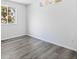 View of a small bedroom with grey vinyl floors, a window, and white walls at 2691 E 132Nd Ave, Thornton, CO 80241