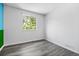 Modest bedroom with grey vinyl floors, a window, and white walls with a colored accent at 2691 E 132Nd Ave, Thornton, CO 80241
