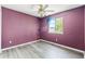 Cozy bedroom with grey vinyl floors, a window, purple walls, and a ceiling fan at 2691 E 132Nd Ave, Thornton, CO 80241