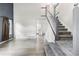 Bright entryway features wood flooring, a staircase with white railings, and a view into the kitchen at 2691 E 132Nd Ave, Thornton, CO 80241