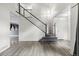 Open entryway with staircase, wood flooring, and natural light, creating a welcoming atmosphere at 2691 E 132Nd Ave, Thornton, CO 80241