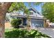 Charming blue two-story home with a well-manicured lawn, attached garage, and mature shade trees at 2691 E 132Nd Ave, Thornton, CO 80241