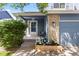 Inviting front porch with a cozy bench, decorative planter, and a well-maintained garden bed at 2691 E 132Nd Ave, Thornton, CO 80241