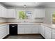 Bright kitchen featuring white cabinets, sleek countertops, and modern black appliances at 2691 E 132Nd Ave, Thornton, CO 80241