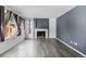 Modern living room featuring wood floors, a fireplace, and ample natural light from large windows at 2691 E 132Nd Ave, Thornton, CO 80241
