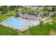 Aerial view of a community pool with lounge chairs, a playground, and parking at 2691 E 132Nd Ave, Thornton, CO 80241