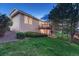 Backyard of home with lawn, trees and view of the home's deck on the back at 7454 Snow Lily Pl, Castle Pines, CO 80108