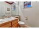 Classic half bathroom with tiled countertop, decorative wallpaper and charming fixtures at 7454 Snow Lily Pl, Castle Pines, CO 80108