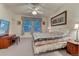 Comfortable bedroom with a ceiling fan, dresser, and a beautifully patterned quilt at 7454 Snow Lily Pl, Castle Pines, CO 80108