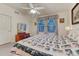 Bright bedroom with a ceiling fan, double windows, and a cozy quilt on the bed at 7454 Snow Lily Pl, Castle Pines, CO 80108