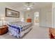 Spacious bedroom boasts neutral carpet, ceiling fan, ensuite access and bright windows at 7454 Snow Lily Pl, Castle Pines, CO 80108